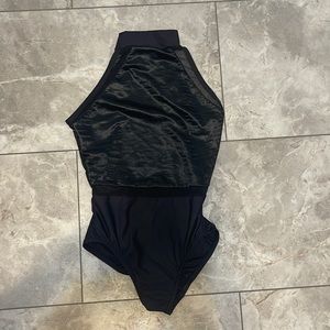 Motionwear size PA black leotard. NWOT. Mesh detailing.